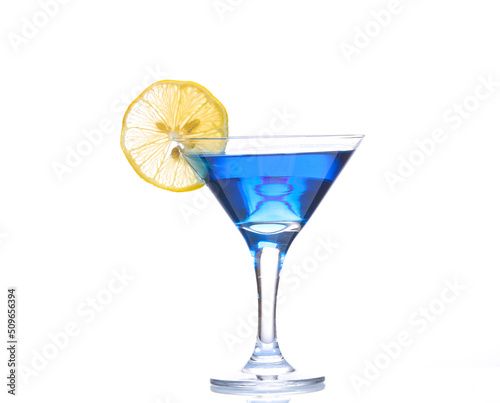 Blue lagoon cocktail in martini glass with lemon slice isolated on white background