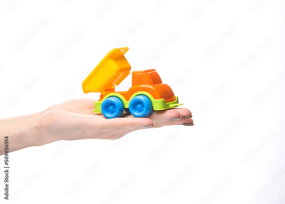 Toy truck car model on palm of the hand isolated on white background