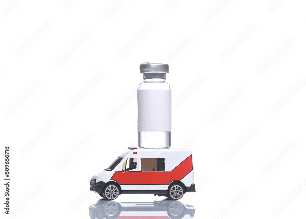 Miniature ambulance with bottle of vaccine isolated on white background with reflection Miniature ambulance with bottle of vaccine isolated on white background with reflection