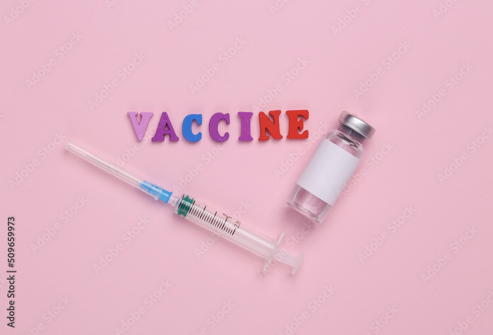 Vaccine bottle with blank label for the brand and syringe, word vaccine on pink background. Covid 19 vaccination Vaccine bottle with blank label for the brand and syringe, word vaccine on pink background. Covid 19 vaccination