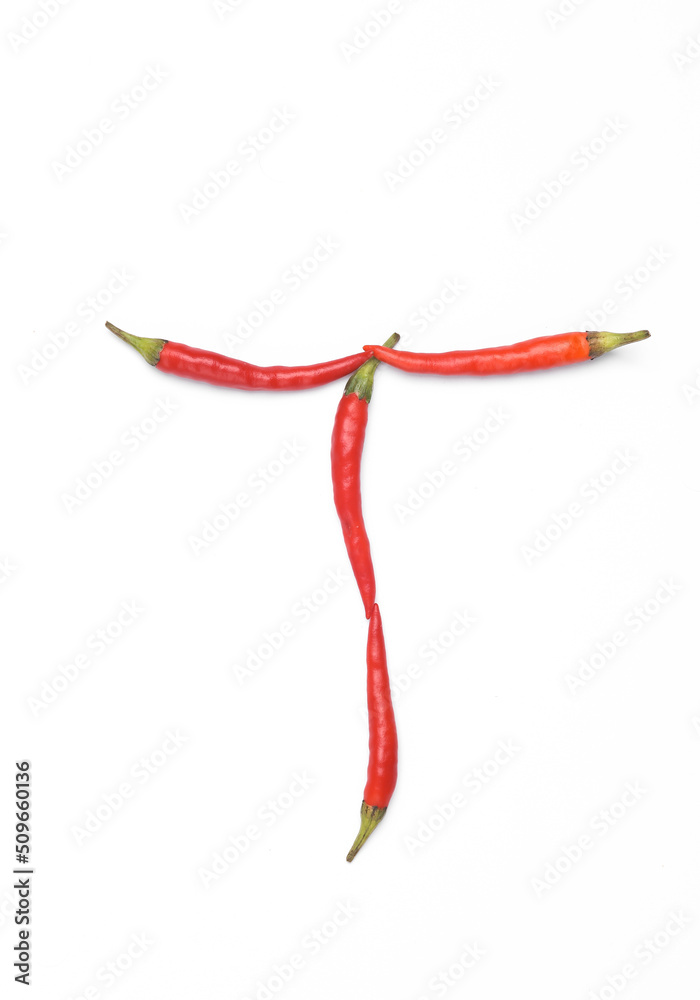 Letter T made from red chilli peppers isolated on white background Letter T made from red chilli peppers isolated on white background