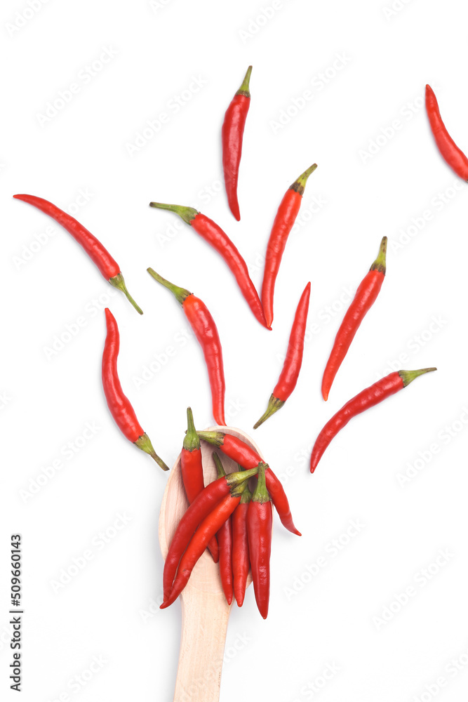 Wooden spoon with red chili pepper isolated on white background Wooden spoon with red chili pepper isolated on white background