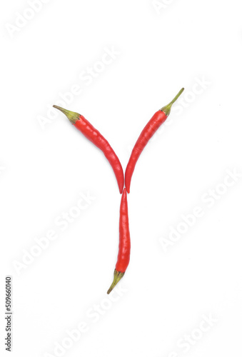 Letter Y made from red chilli peppers isolated on white background