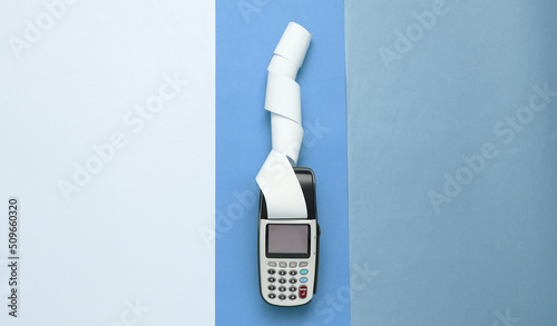 Payment terminal with paper tape on colored background