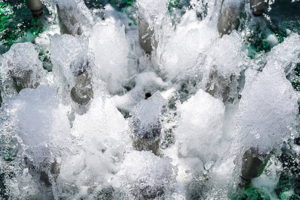 Many small fountains with multi-colored illumination. Close up