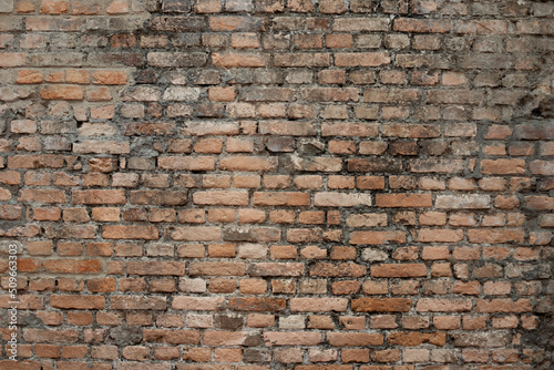 Exposed brick texture. Wall built with blocks. Construction  photo background  backdrop. Orange brick  old red. Old construction.