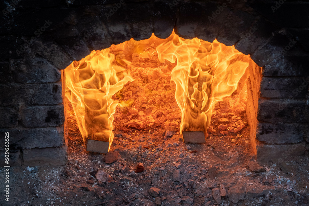 Firing of wood fire kiln is part of process for black pottery. Unique ...