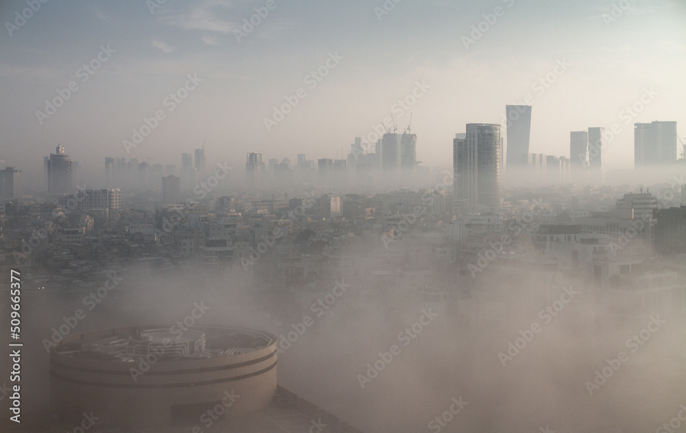Heavy fog in Tel Aviv. Panorama above. The city over the clouds