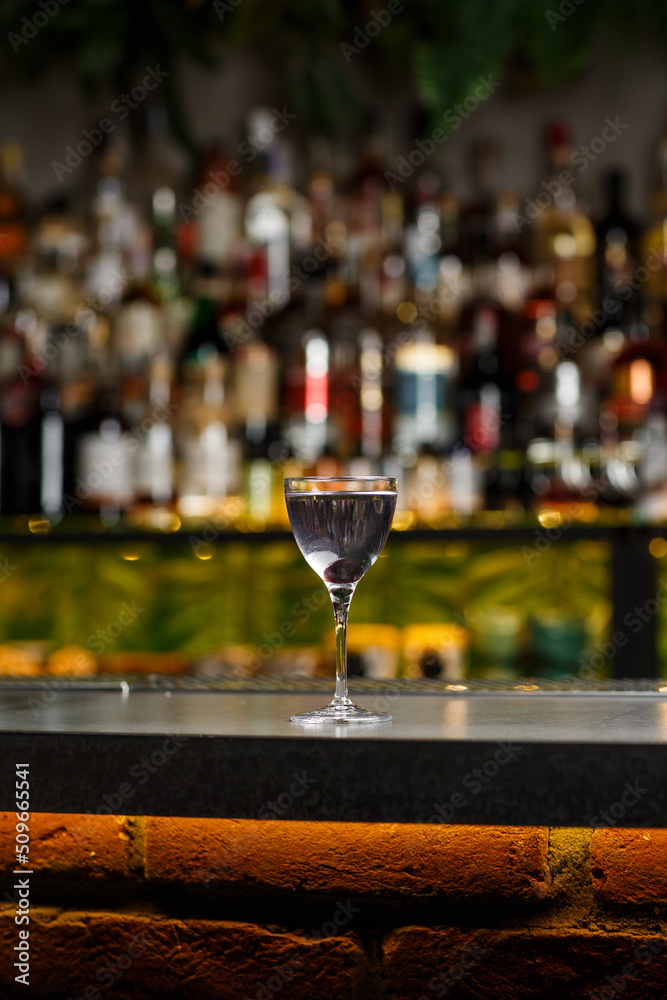 Aviation, drink with gin, lemon juice, maraschino liqueur and violet cream liqueur standing on bar counter.