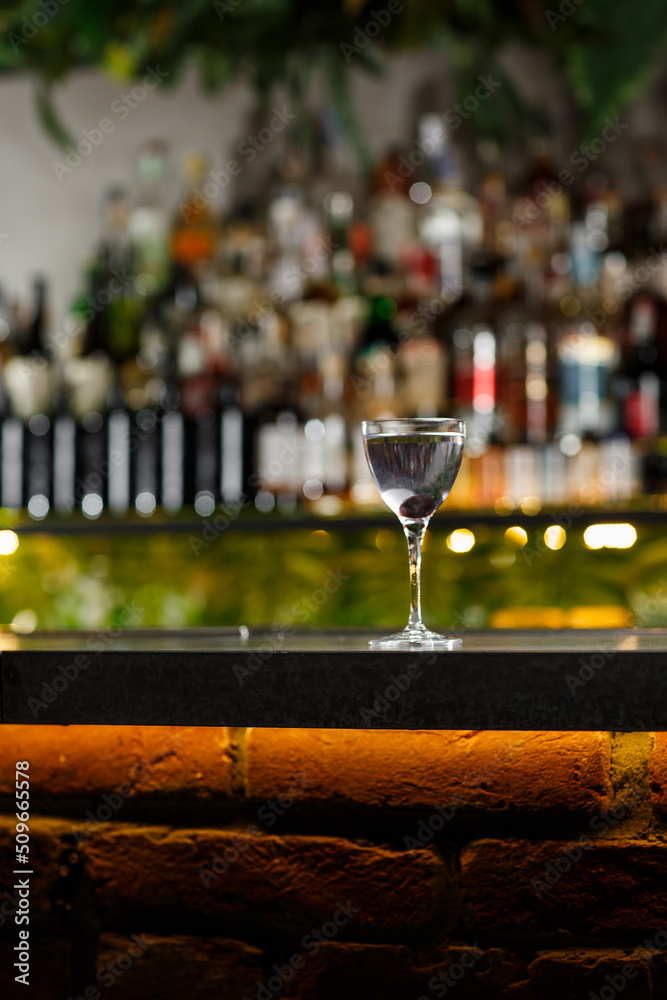 Aviation, drink with gin, lemon juice, maraschino liqueur and violet cream liqueur standing on bar counter.