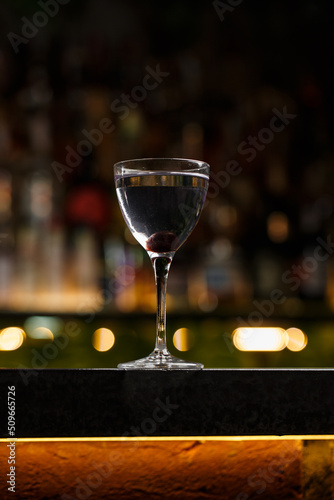 Aviation, drink with gin, lemon juice, maraschino liqueur and violet cream liqueur standing on bar counter.