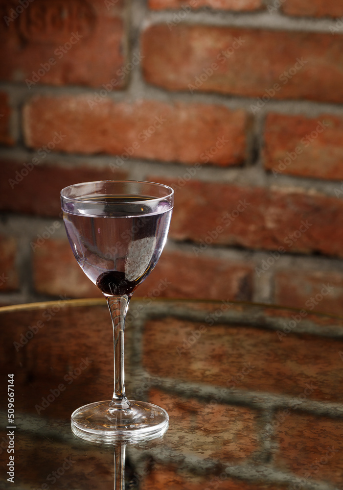 Aviation, drink with gin, lemon juice, maraschino liqueur and violet cream liqueur standing on bar counter.