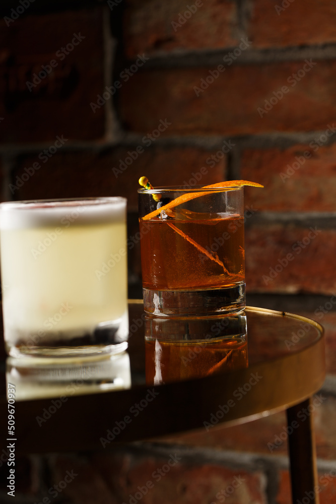 Pisco sour cocktail - whiskey with lime, egg white, sugar syrup in glass on dark background. Space for text