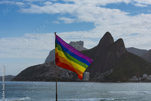 Rio de Janeiro, Brazil. Gay flag fluttering. Ipanema beach sea and two brothers hill in the background.