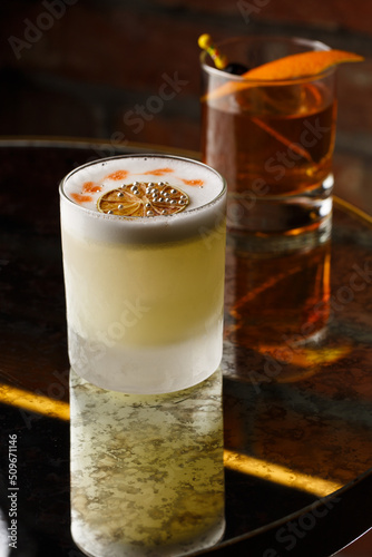 Obraz na płótnie Pisco sour cocktail - whiskey with lime, egg white, sugar syrup in glass on dark background. Space for text w salonie