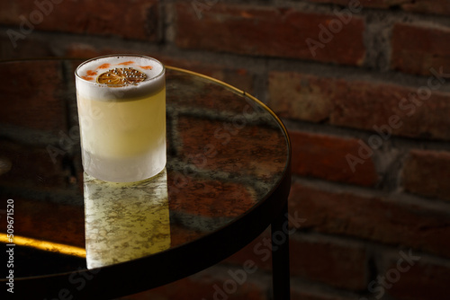 Obraz na płótnie Pisco sour cocktail - whiskey with lime, egg white, sugar syrup in glass on dark background. Space for text w salonie