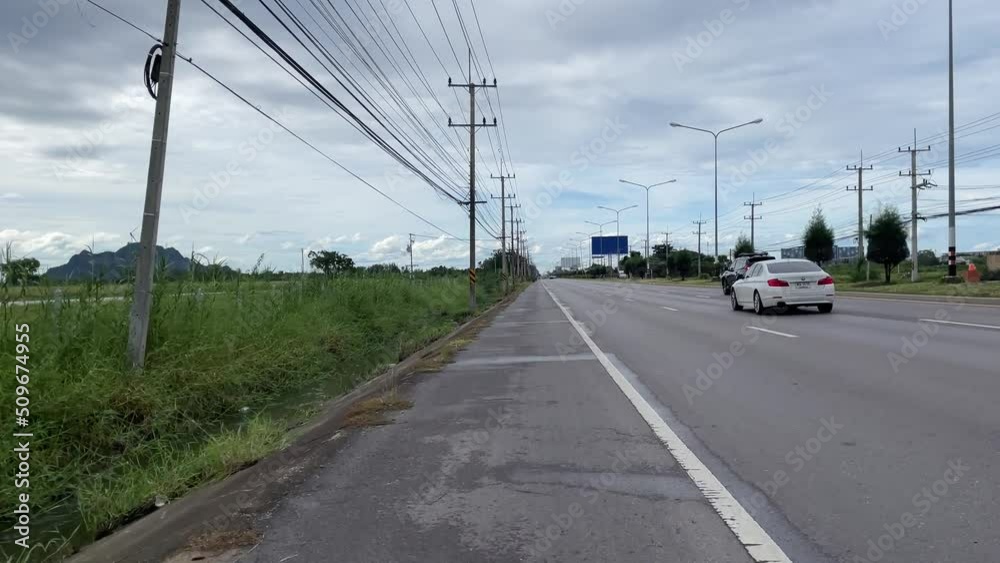 Driving on road nature view with vehicles passing by on road daytime. POV motion forward shot trees on road side. Driving on road nature view with vehicles passing by on road daytime. POV motion forward shot trees on road side.