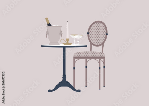 An outdoor french cafe table with a rattan chair, a champagne bucket, a candlestick, and sparkling wine glasses