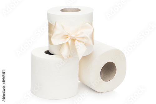 Three rolls of toilet paper on an isolated white background. One roll with an elegant light bow.