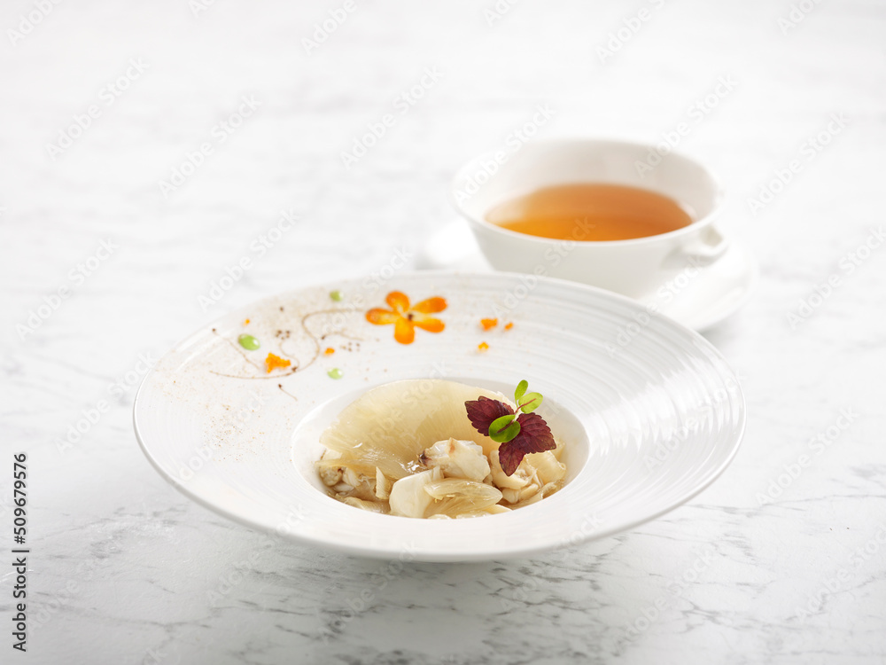 Sauteed Superior Shark’s Fin with Fresh Crab Meat served with Superior Broth served in a bowl isolated on grey background Sauteed Superior Shark’s Fin with Fresh Crab Meat served with Superior Broth served in a bowl isolated on grey background