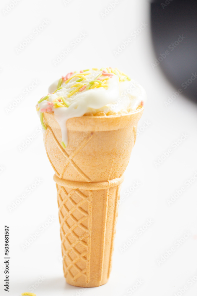 ice cream cone on white background and sugar particles on it ice cream cone on white background and sugar particles on it