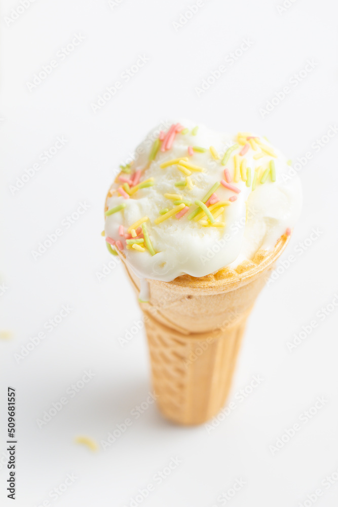 ice cream cone on white background and sugar particles on it ice cream cone on white background and sugar particles on it
