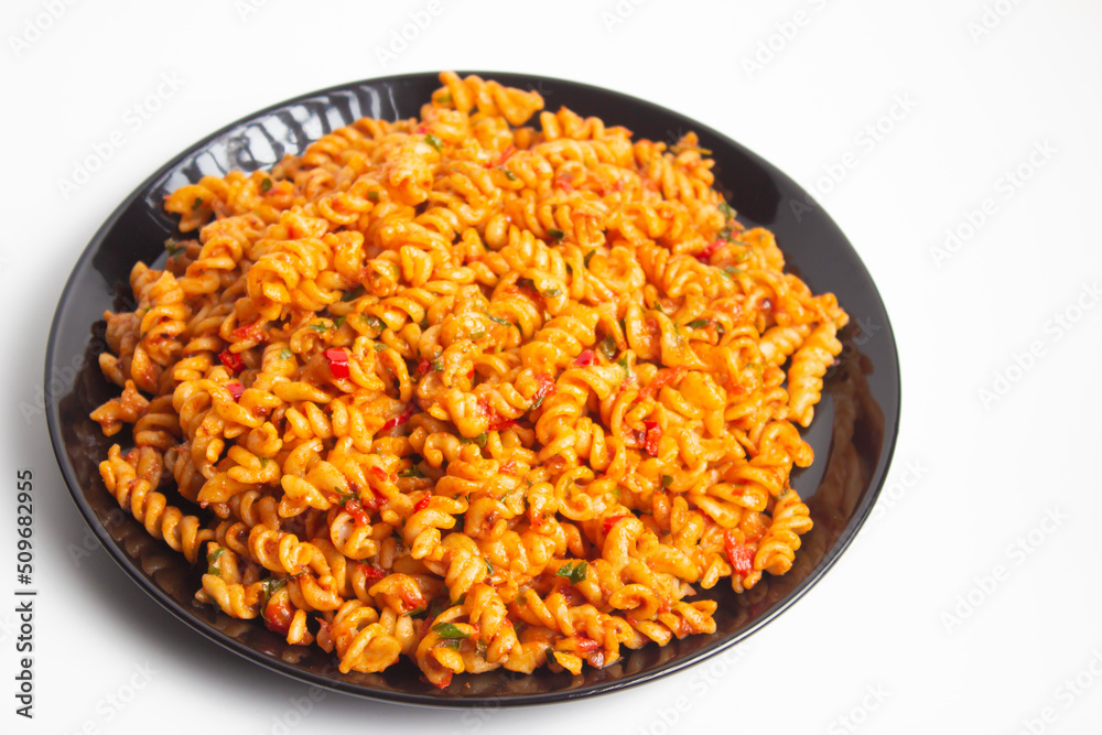 auger pasta on black plate on white background auger pasta on black plate on white background