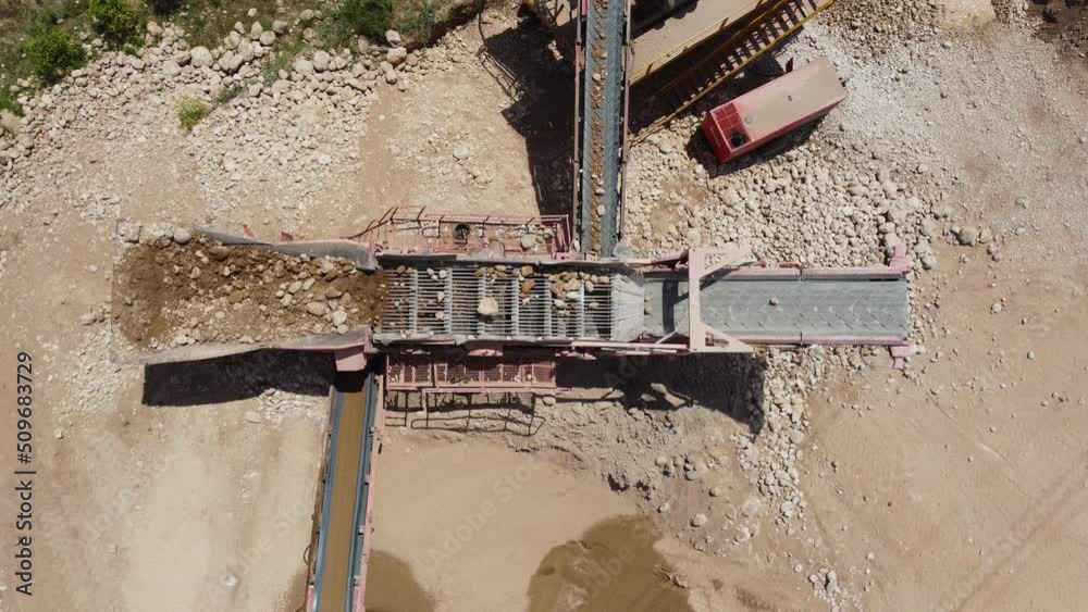 Top view of a sieving machine classifying aggregates in a screening plant. Mining industry equipment