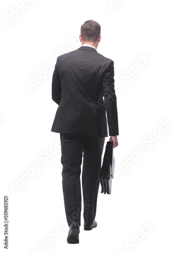 rear view . business man with leather briefcase stepping forward