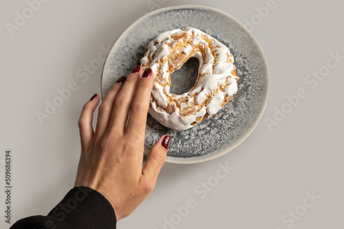 Female hand with cookies.Brewing cake. Cake. Choux pastry with fruit. Airy cakes with delicate and aromatic cream
