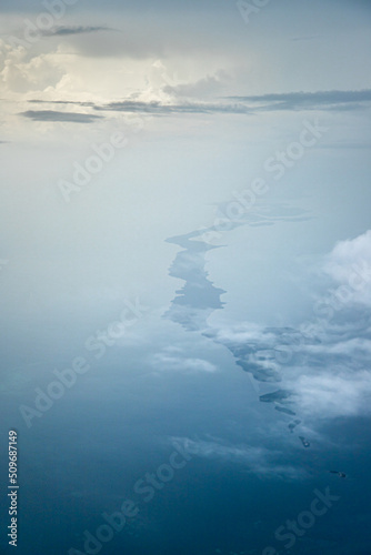 Aerial view of an Island with a few clouds