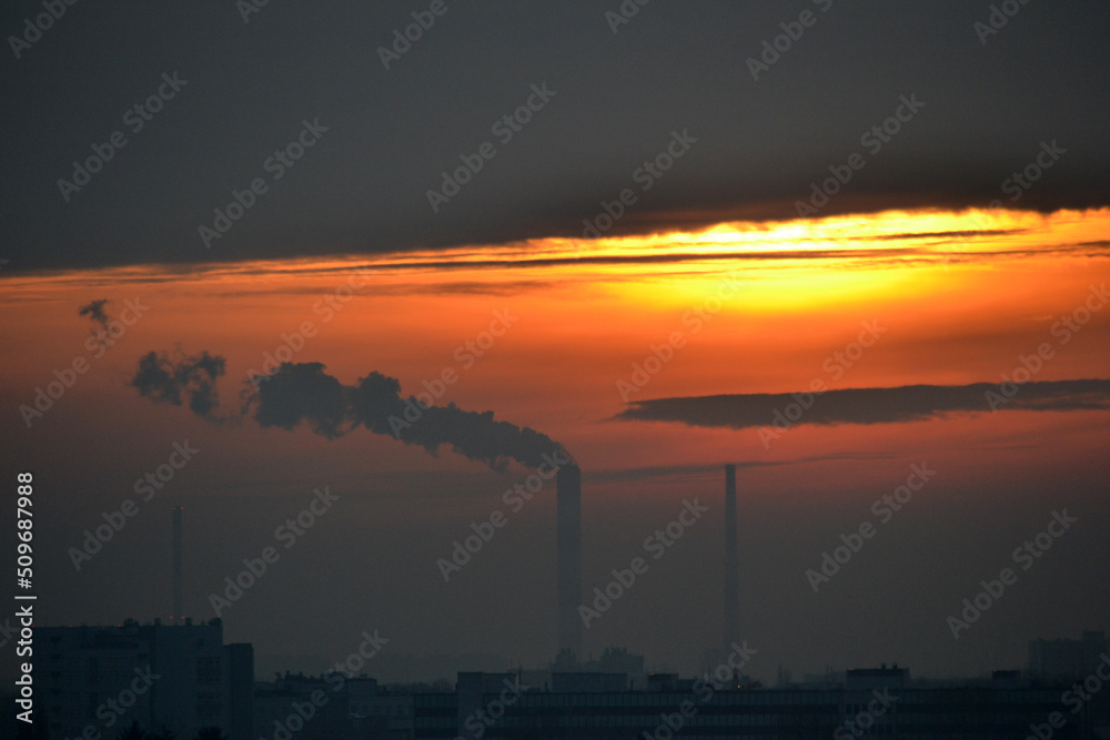 Smoke coming from factory's chimney at sunset