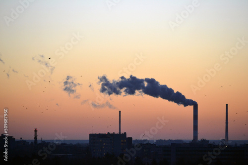 Smoke coming from factory's chimney at sunset