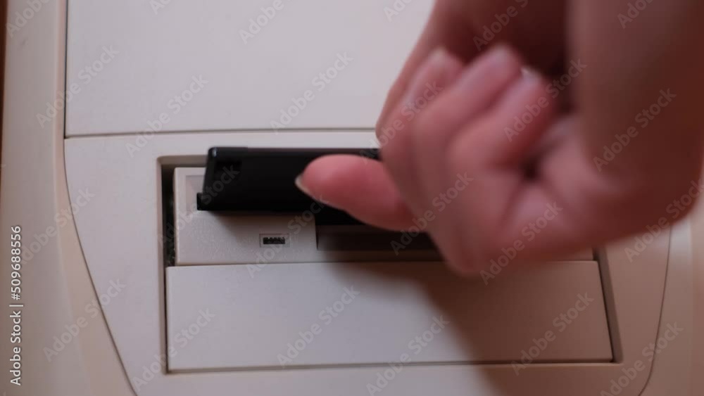 Old computer with disk drive. Shooting the process of removing a floppy disk, close up