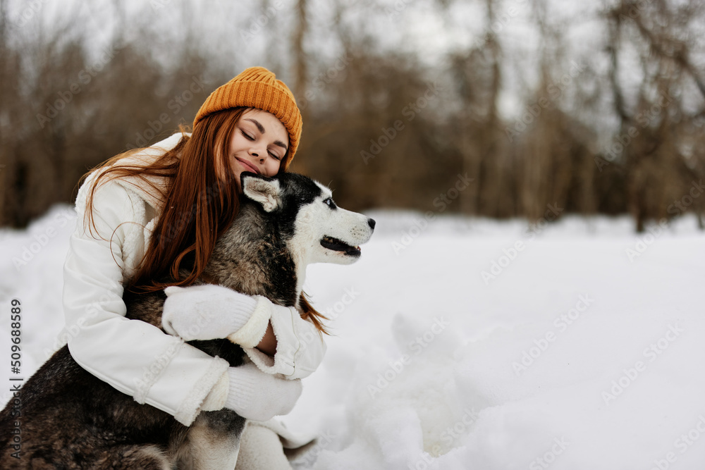 cheerful woman outdoors in a field in winter walking with a dog winter holidays