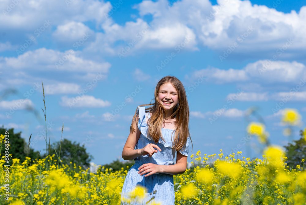 Happy smiling teenage girl having fun in nature. Ukrainian girl on yellow and blue background. Colors of Ukrainian flag. Happy smiling teenage girl having fun in nature. Ukrainian girl on yellow and blue background. Colors of Ukrainian flag.