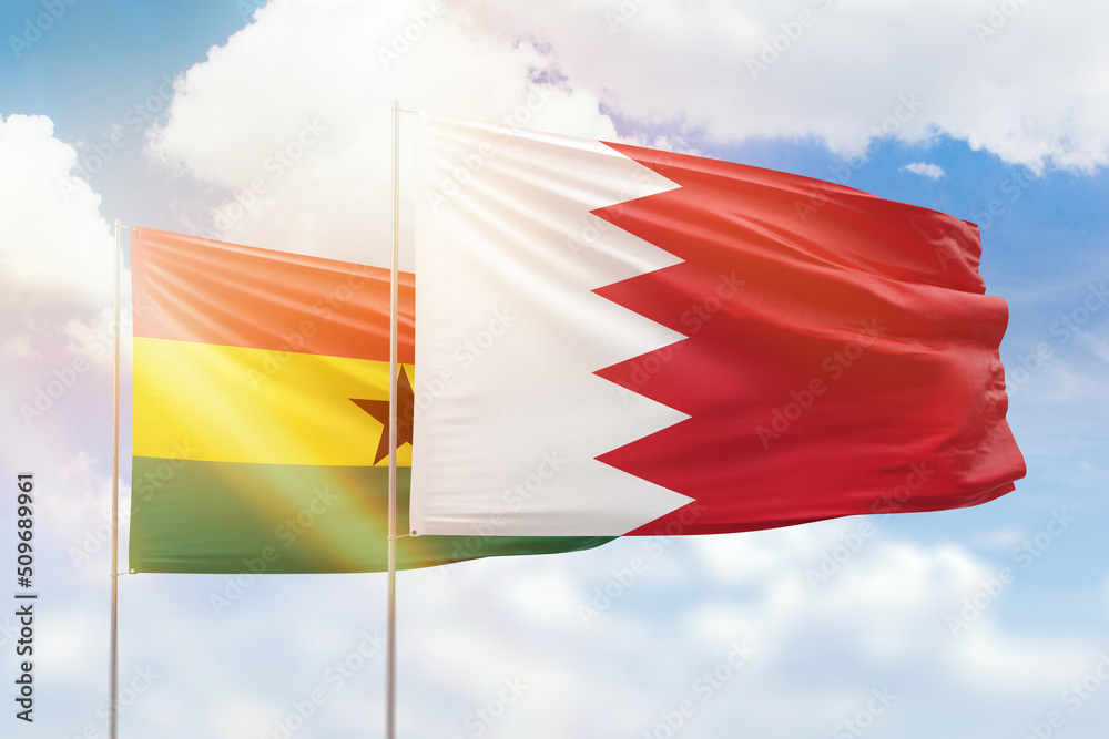 Sunny blue sky and flags of bahrain and ghana Sunny blue sky and flags of bahrain and ghana
