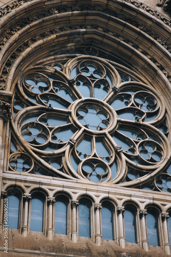 Old openwork round window with stained glass on facade of the building. Baroque and Gothic architecture. Church of St. Olga and Elizabeth. Lviv  Ukraine.