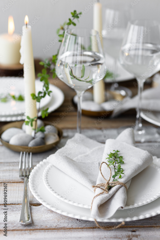 Rustic zero waste wedding decor with natural elements. Wooden table, candles, linen napkins, branches with green leaves. Eco-friendly decoration for the special dinner. Romantic and cozy place Rustic zero waste wedding decor with natural elements. Wooden table, candles, linen napkins, branches with green leaves. Eco-friendly decoration for the special dinner. Romantic and cozy place