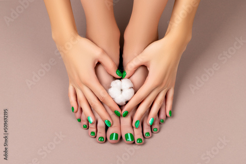 Manicure, pedicure beauty salon concept. Womans feet with cotton flower