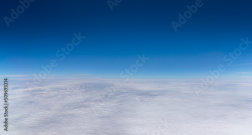 Blue Sky on top with white fluffy clouds on the bottom