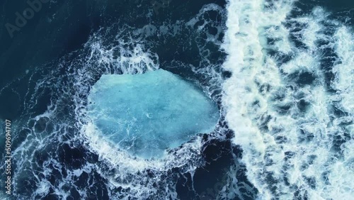Iceberg in the ocean, Huge Chunks of Blue Ice floating on the waves, Arctic landscape aerial view, clean water, global warming and climate change concept