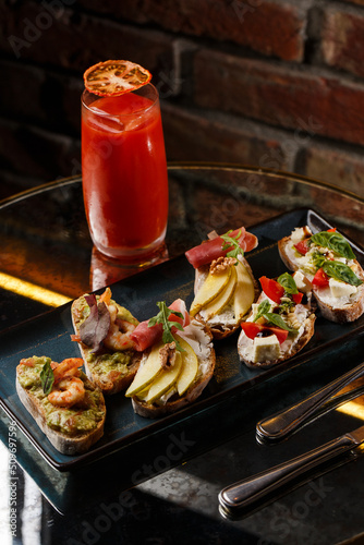 Obraz na płótnie Bruschettas with vegetables. Start dishes with cherry tomatoes, avocado, cream cheese and shrimps. Food composition, tasty italian meal w salonie