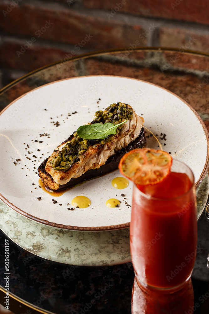 Baked eggplant stuffed with grilled chicken, tomatoes and spices on white plate. Traditional dish Karniyarik of turkish cuisine. View from above