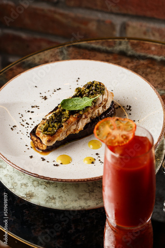 Obraz na płótnie Baked eggplant stuffed with grilled chicken, tomatoes and spices on white plate. Traditional dish Karniyarik of turkish cuisine. View from above w salonie