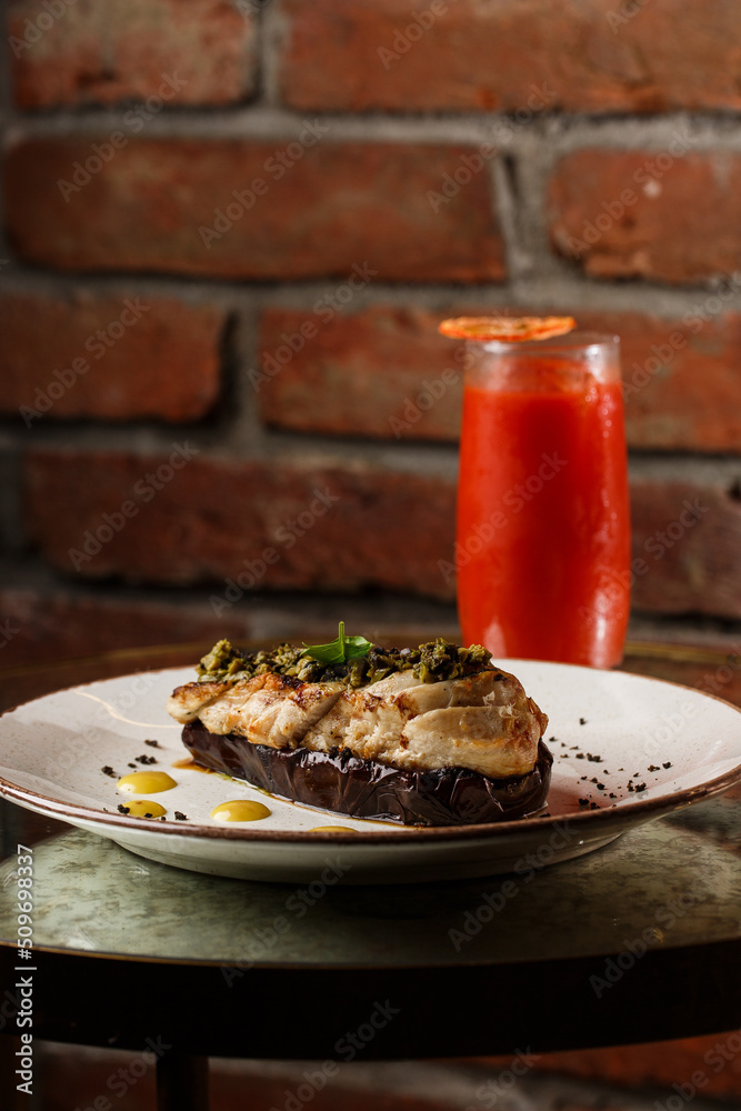 Baked eggplant stuffed with grilled chicken, tomatoes and spices on white plate. Traditional dish Karniyarik of turkish cuisine. View from above