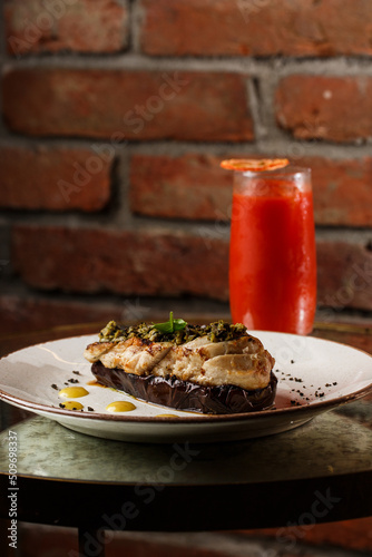 Obraz na płótnie Baked eggplant stuffed with grilled chicken, tomatoes and spices on white plate. Traditional dish Karniyarik of turkish cuisine. View from above w salonie