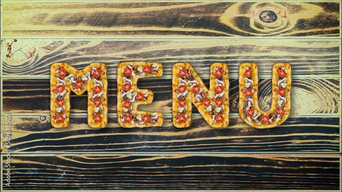 The word Menu made of pizza on the background of boards