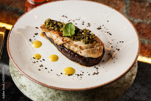 Obraz na płótnie Baked eggplant stuffed with grilled chicken, tomatoes and spices on white plate. Traditional dish Karniyarik of turkish cuisine. View from above w salonie