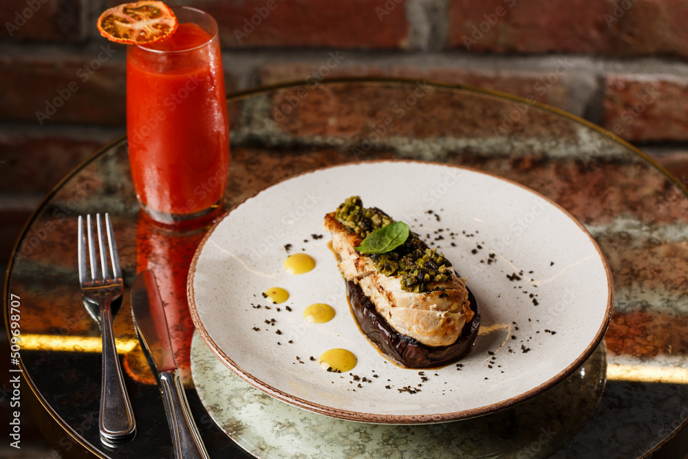 Baked eggplant stuffed with grilled chicken, tomatoes and spices on white plate. Traditional dish Karniyarik of turkish cuisine. View from above